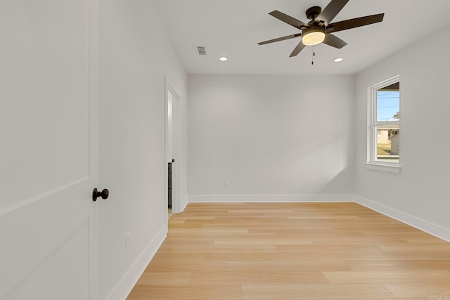 empty room with ceiling fan and light wood-type flooring