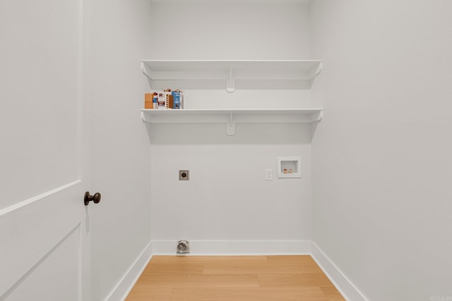 clothes washing area featuring hardwood / wood-style flooring, electric dryer hookup, and washer hookup