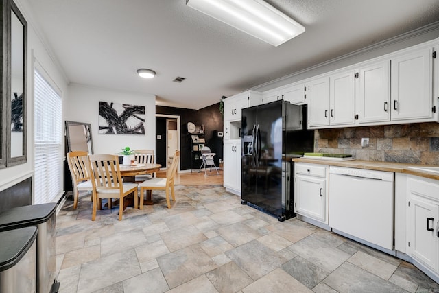 kitchen featuring decorative backsplash, black fridge, crown molding, dishwasher, and white cabinetry