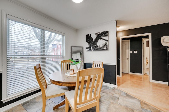 dining room featuring light wood-type flooring and ornamental molding