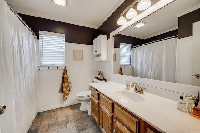 bathroom featuring vanity, a healthy amount of sunlight, and crown molding