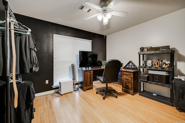 office featuring ceiling fan, a textured ceiling, and hardwood / wood-style flooring