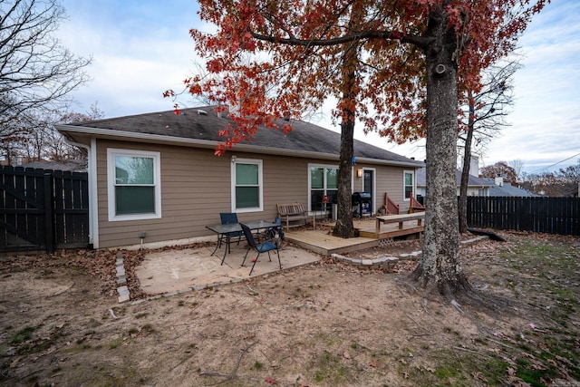 back of property featuring a deck