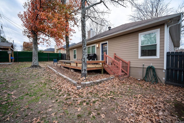 back of property with a wooden deck