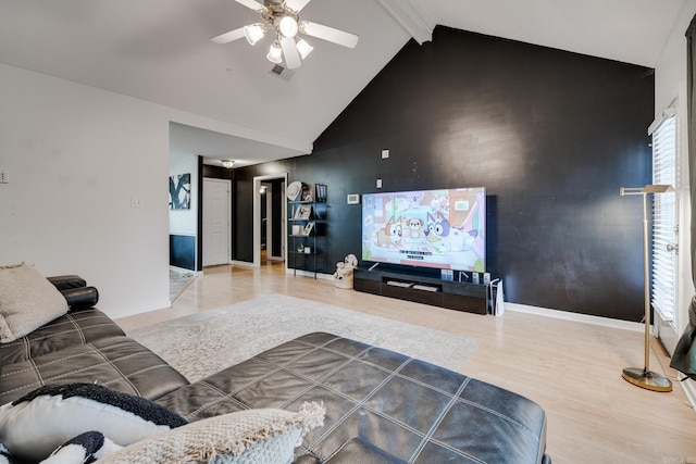 living room featuring hardwood / wood-style floors, vaulted ceiling with beams, and ceiling fan