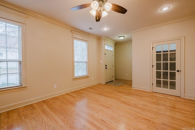 spare room with ceiling fan, light hardwood / wood-style flooring, a healthy amount of sunlight, and ornamental molding