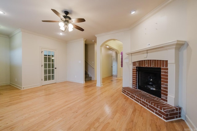 unfurnished living room with a fireplace, ceiling fan, light hardwood / wood-style flooring, and ornamental molding