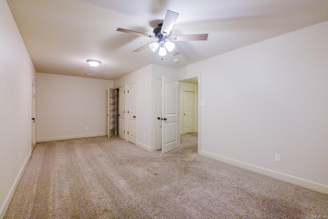 empty room featuring light carpet and ceiling fan