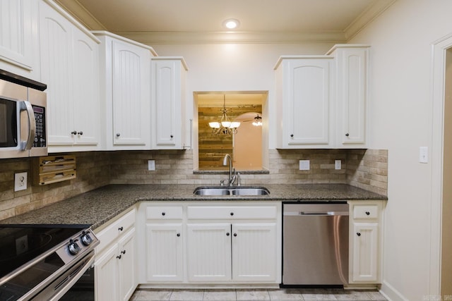 kitchen featuring decorative backsplash, white cabinetry, sink, and appliances with stainless steel finishes