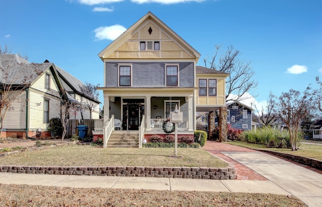 view of front of house featuring a front yard and a porch