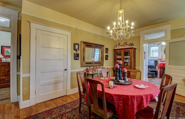 dining room featuring an inviting chandelier and light wood-type flooring