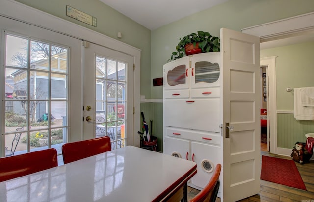 dining room with french doors and wood-type flooring