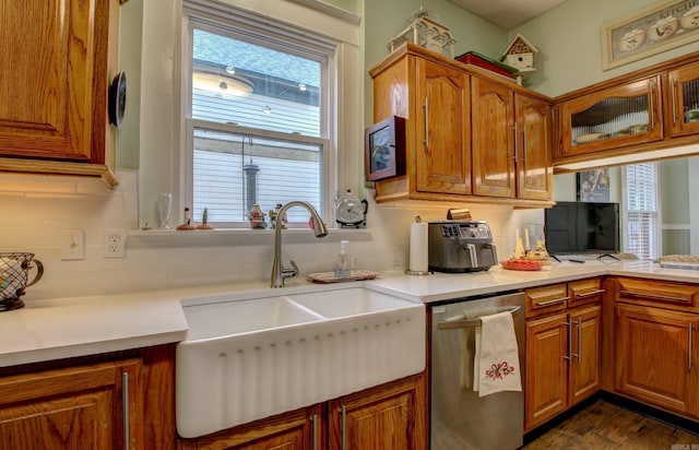 kitchen featuring backsplash, a wealth of natural light, and stainless steel dishwasher