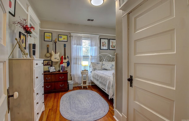 bedroom with wood-type flooring