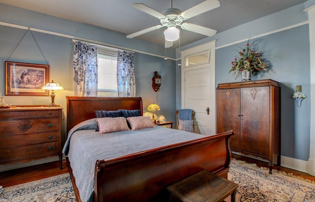 bedroom with ceiling fan and light hardwood / wood-style floors