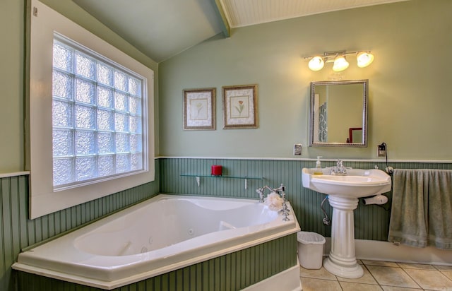 bathroom with tile patterned floors, a tub to relax in, and lofted ceiling with beams