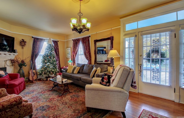 living room with hardwood / wood-style floors and a chandelier