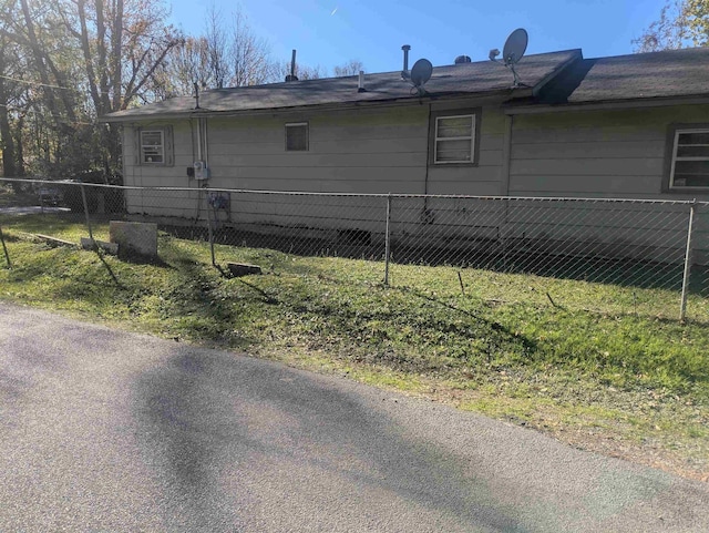 view of side of home featuring a yard