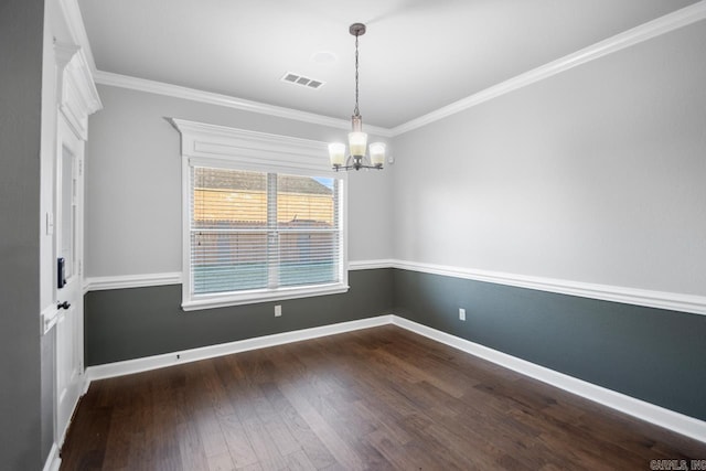 unfurnished room with a chandelier, dark hardwood / wood-style floors, and ornamental molding