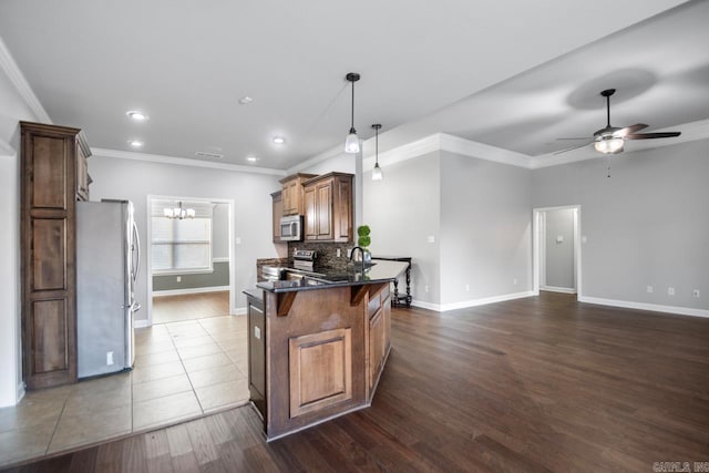 kitchen featuring ceiling fan with notable chandelier, dark hardwood / wood-style flooring, stainless steel appliances, and ornamental molding