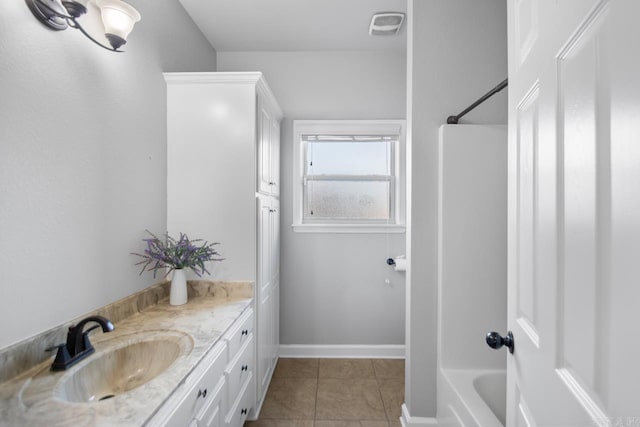 bathroom featuring vanity, tile patterned floors, and tub / shower combination