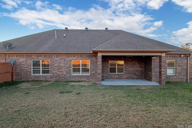 rear view of house with a yard and a patio