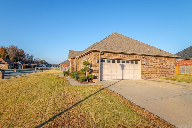 view of side of property with a lawn and a garage