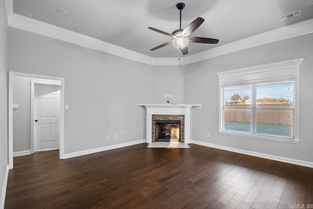 unfurnished living room featuring dark hardwood / wood-style flooring, crown molding, a fireplace, and ceiling fan