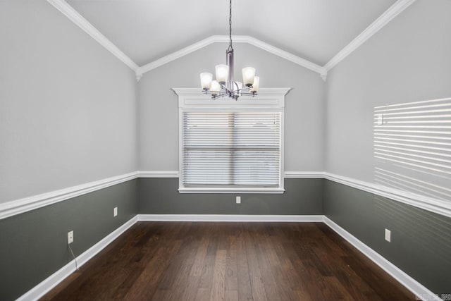 empty room featuring a chandelier, dark wood-type flooring, vaulted ceiling, and crown molding