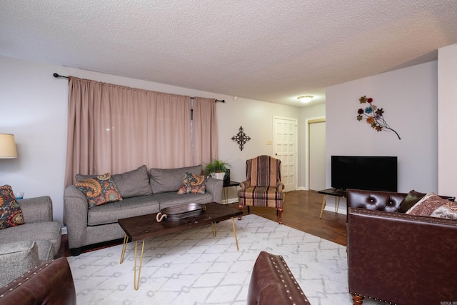 living room featuring a textured ceiling and light wood-type flooring