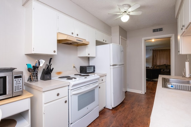 kitchen with white cabinetry, dark hardwood / wood-style flooring, white appliances, and a textured ceiling