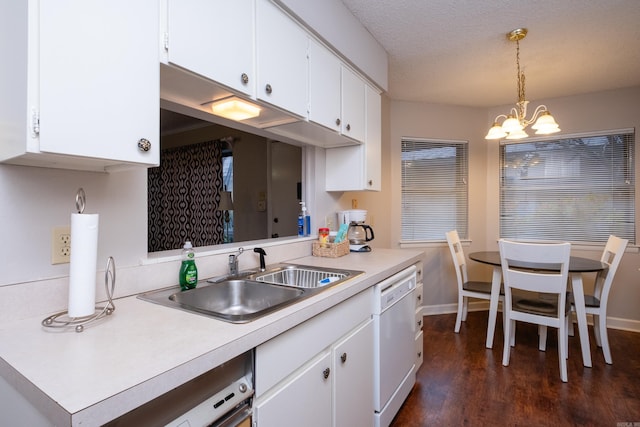 kitchen featuring white cabinets, sink, white dishwasher, and decorative light fixtures