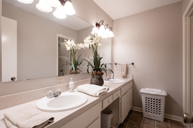 bathroom featuring a textured ceiling and vanity