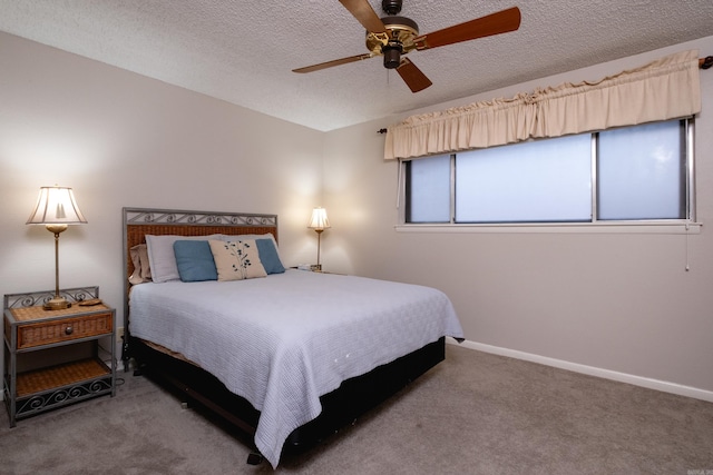 carpeted bedroom with ceiling fan and a textured ceiling