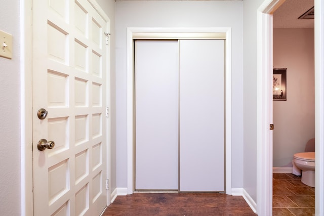 interior space with hardwood / wood-style floors and toilet