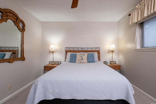 carpeted bedroom featuring a textured ceiling and ceiling fan