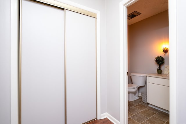 bathroom featuring tile patterned floors and toilet