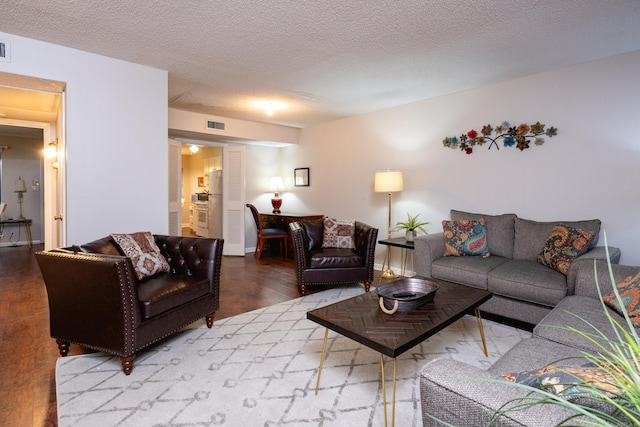 living room featuring a textured ceiling and hardwood / wood-style flooring