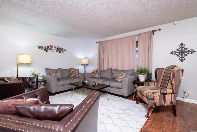 living room featuring a textured ceiling and light wood-type flooring