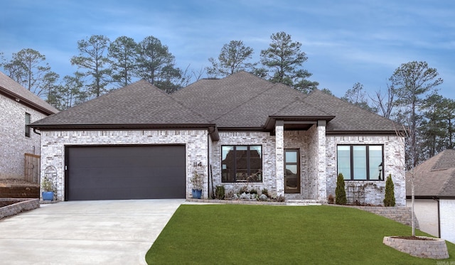 view of front of house with a garage and a front lawn