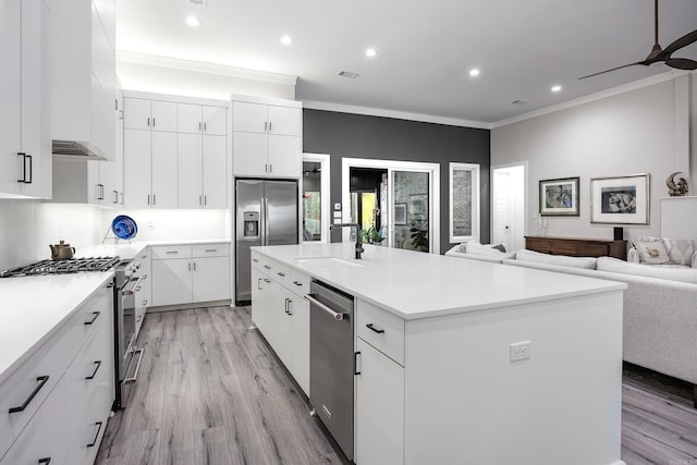 kitchen featuring a kitchen island with sink, light hardwood / wood-style flooring, white cabinets, and appliances with stainless steel finishes