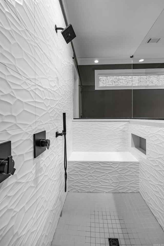 bathroom featuring tiled shower and ornamental molding