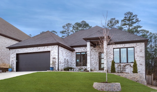 view of front of house with a front yard and a garage