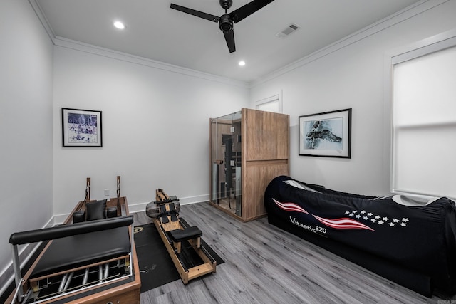 interior space featuring ceiling fan, light hardwood / wood-style floors, and ornamental molding