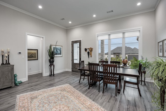 dining area featuring hardwood / wood-style floors and ornamental molding