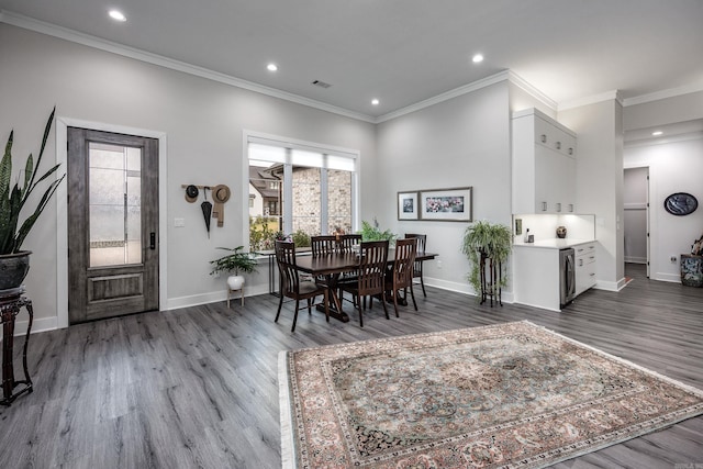 dining space with crown molding and dark wood-type flooring