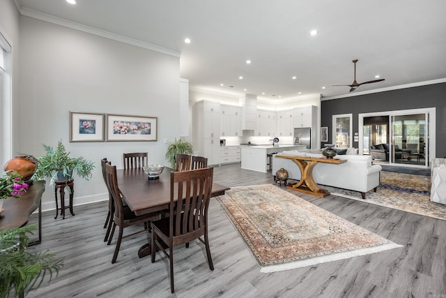 dining room with light hardwood / wood-style flooring and ornamental molding