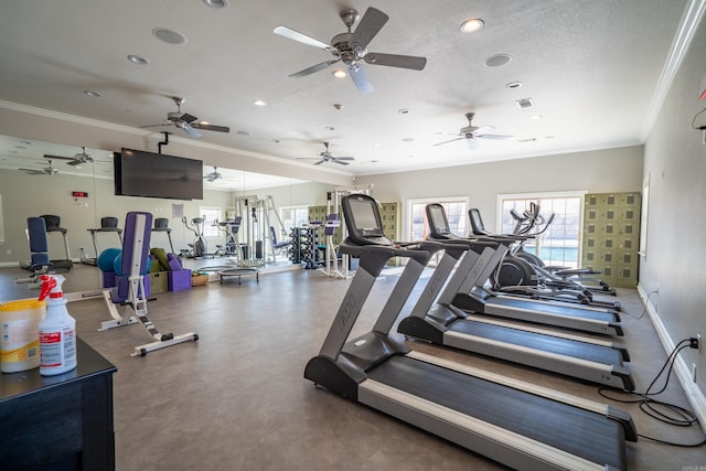 workout area featuring a textured ceiling and crown molding