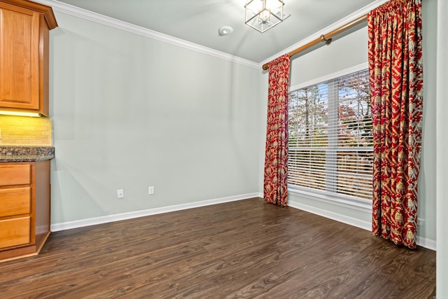 unfurnished dining area with dark wood-type flooring and ornamental molding