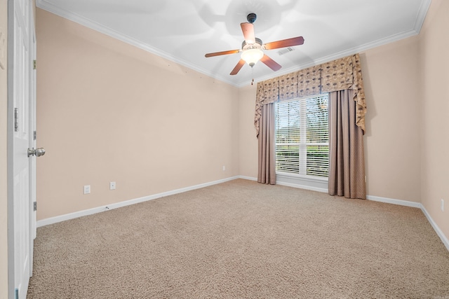 carpeted spare room with ceiling fan and crown molding